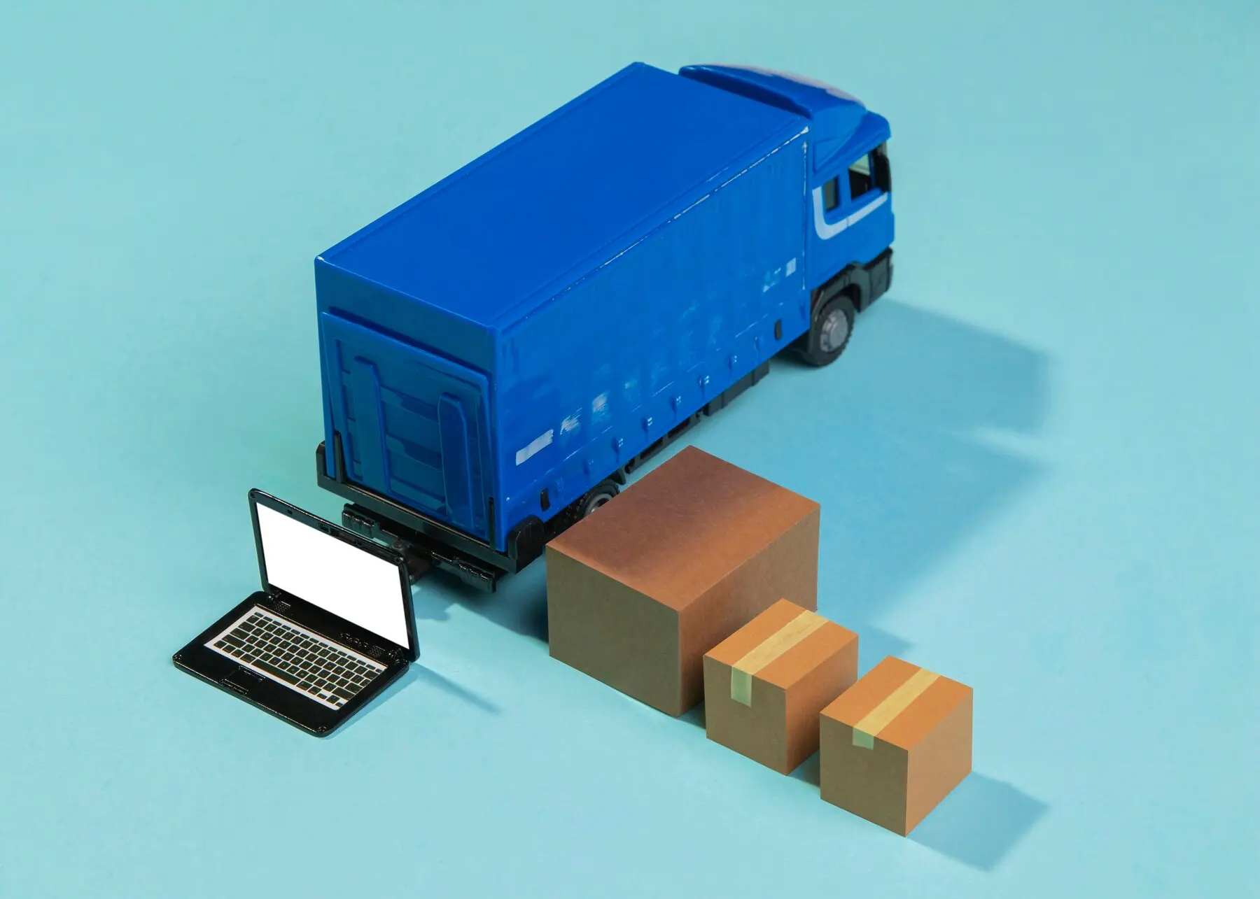 Freight services illustration with truck, boxes, and laptop